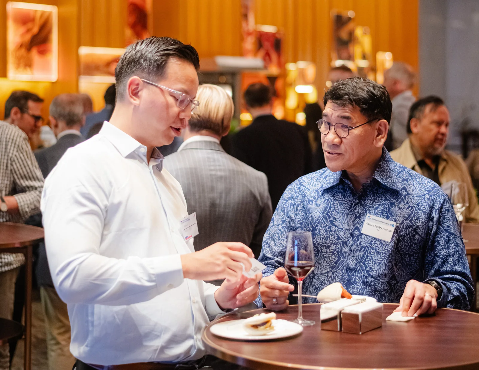 Two guests in conversation at the 2026 EIBN New Year reception.