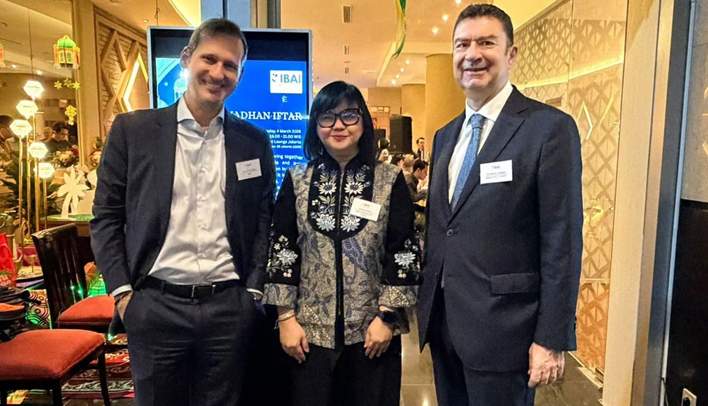 Three smiling guests at IBAI’s Ramadan iftar in Jakarta, 4 March 2026.